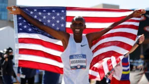 Celebrating immigrant Olympic athletes. Pictured is Team USA's Abdi Abdirahman holding up the U.S. flag. Photo credit: teamUSA.com