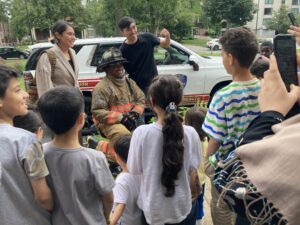 Members of the Buffalo Fire Department presented safety tips and posed with attendees during IIB's Community Orientation for newly arrived refugees.