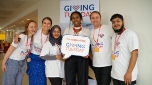 People holding a Giving Tuesday sign